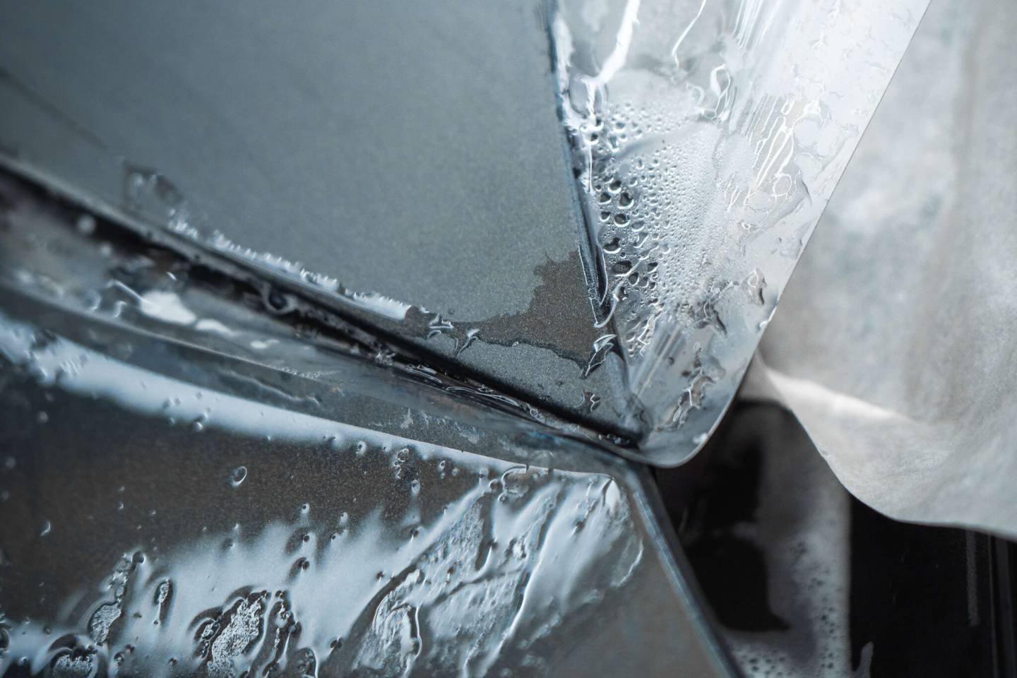 Close-up of clear protective film wrapped around a panel corner