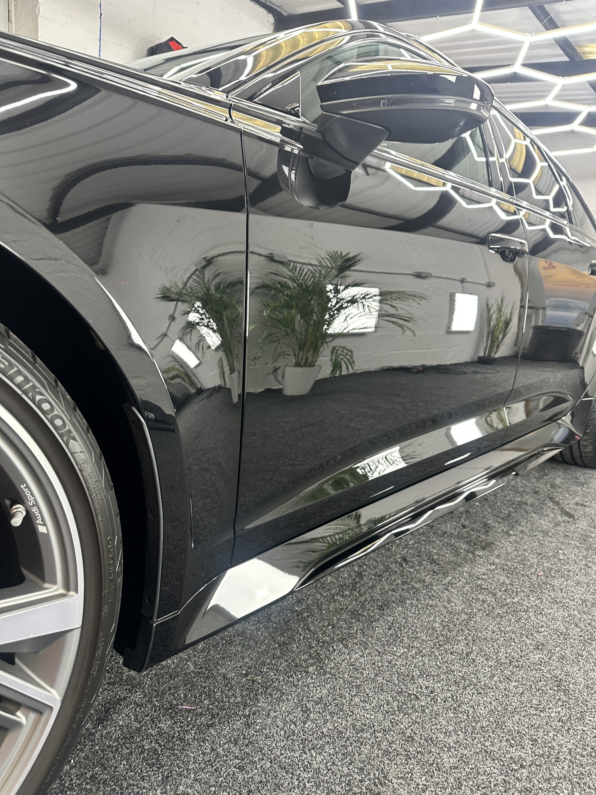 Gloss black Audi RS6 side panel after professional detailing