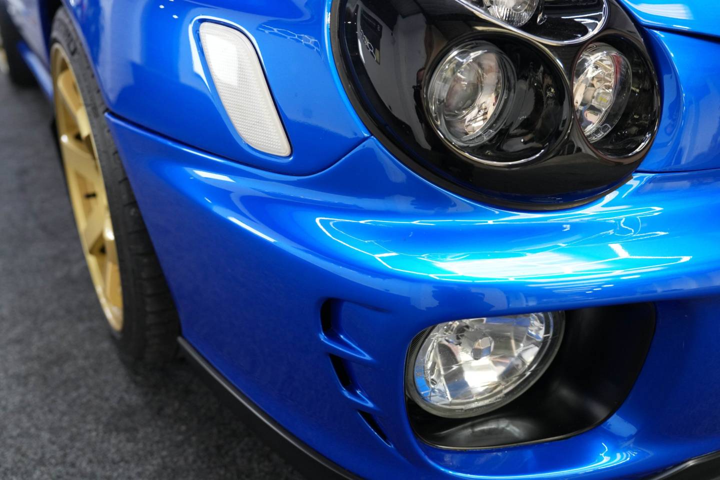 Blue Subaru Impreza headlamp and fog light detail