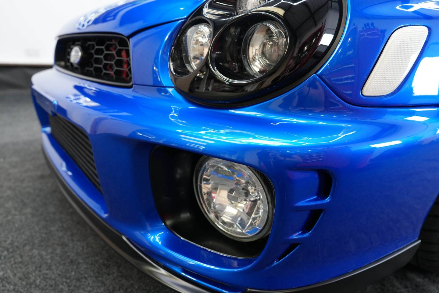 Blue Subaru Impreza headlamp and front bumper