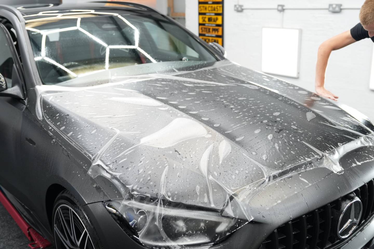 Application solution on a grey vehicle bonnet