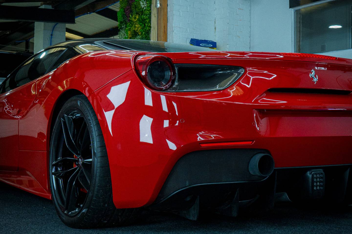 Rear view of a red Ferrari in the workshop