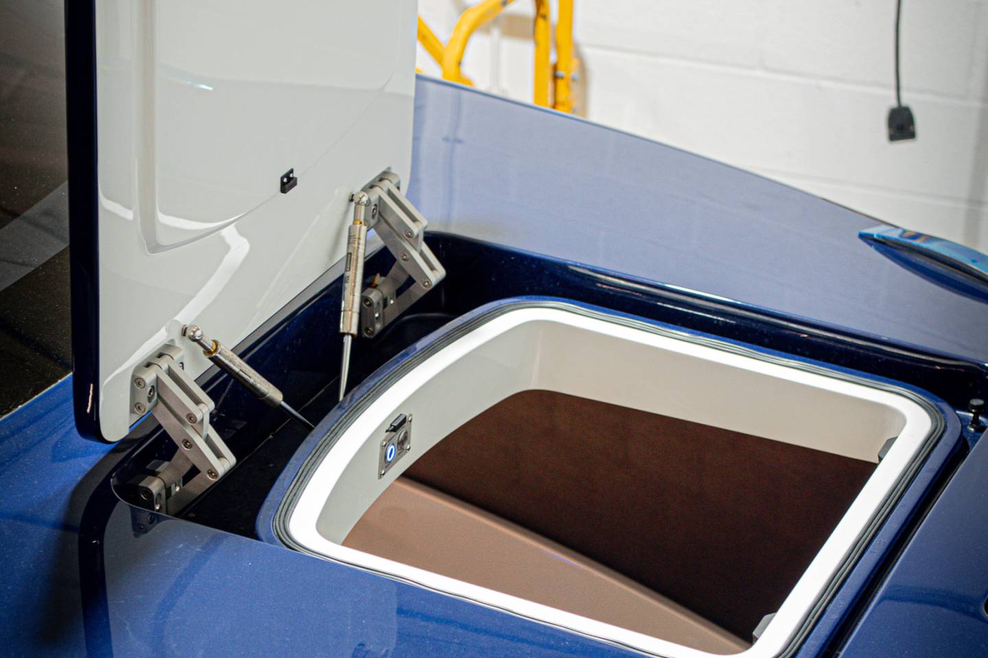 Blue classic sports car bodywork beside the open cockpit