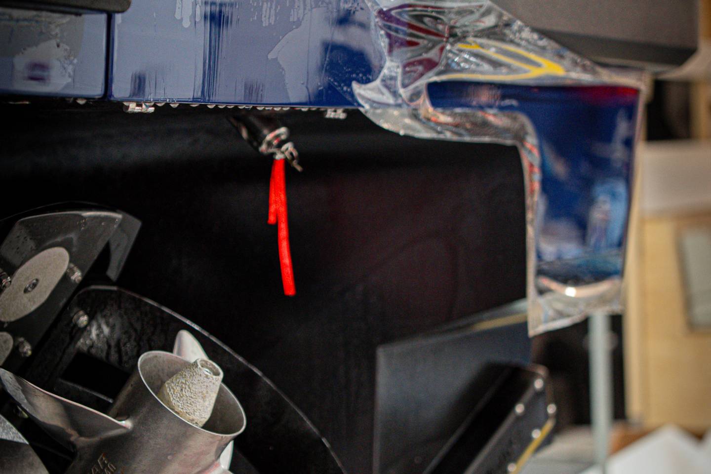 Close-up of blue vehicle bodywork during film installation