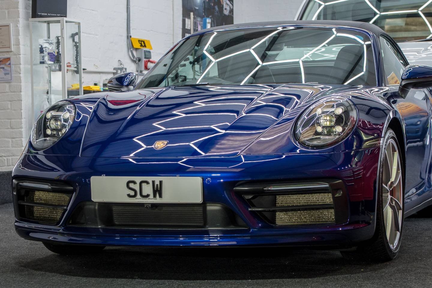 Front three-quarter view of a blue Porsche