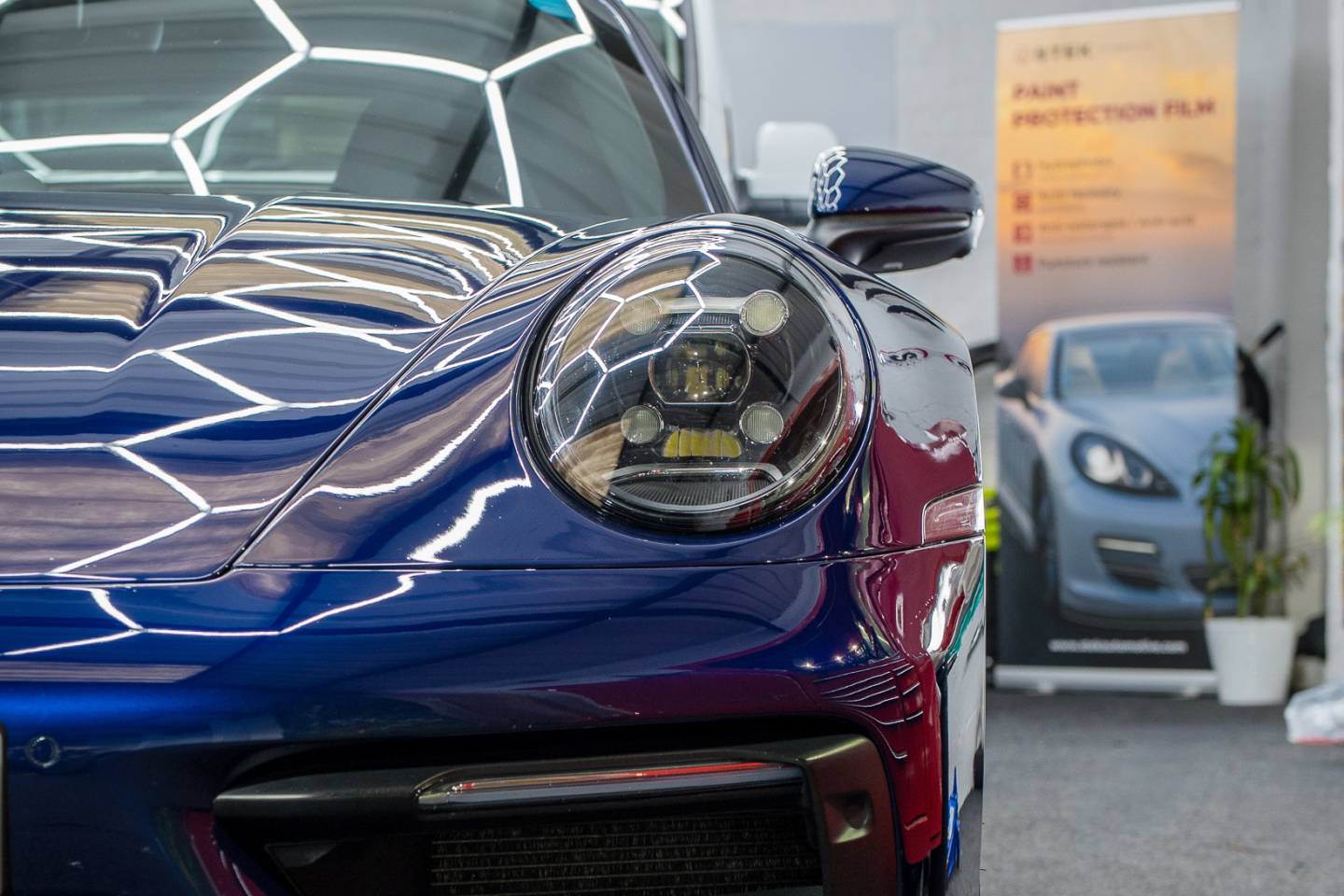 Blue Porsche headlamp and front wing