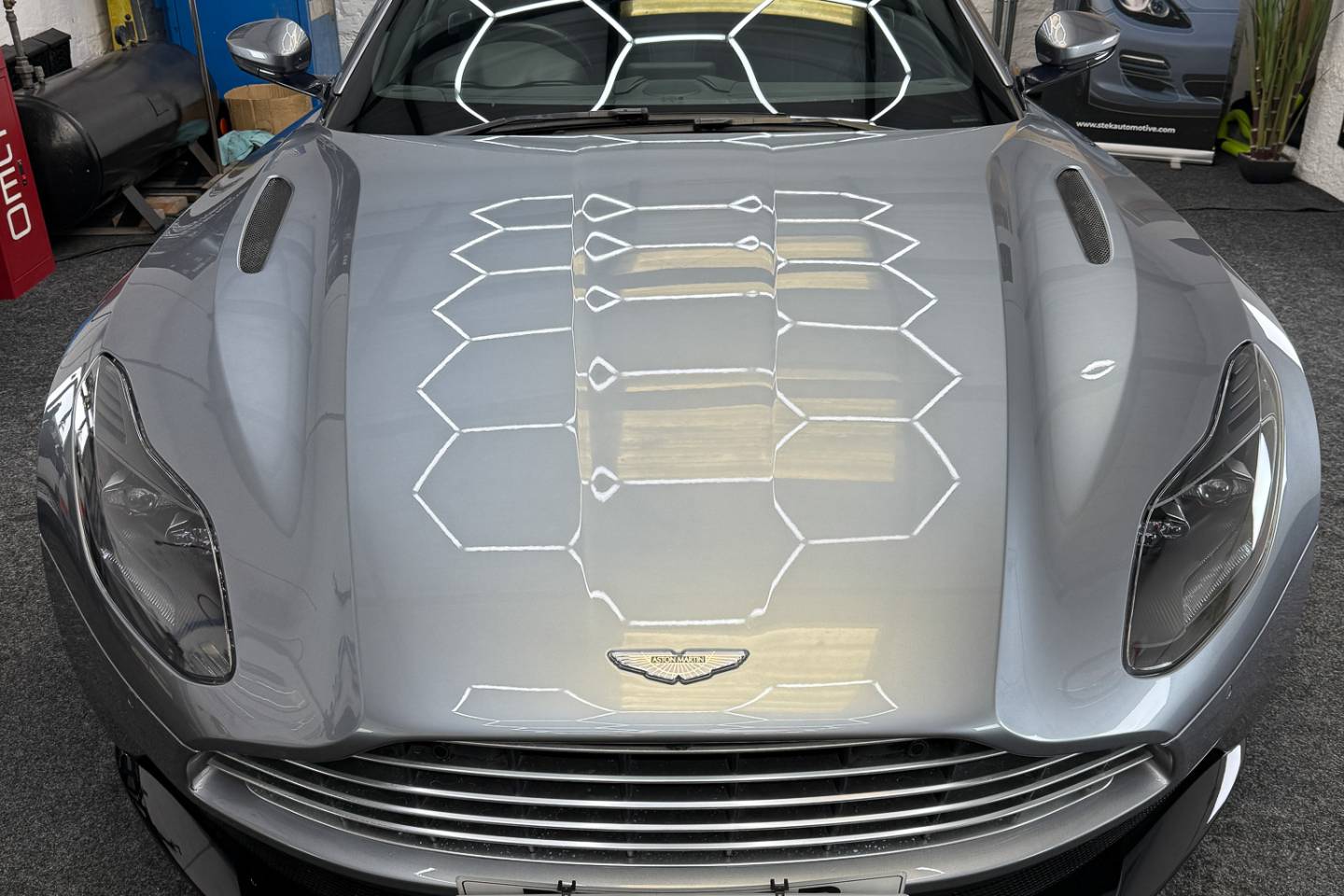 Front view of a grey sports car in the workshop