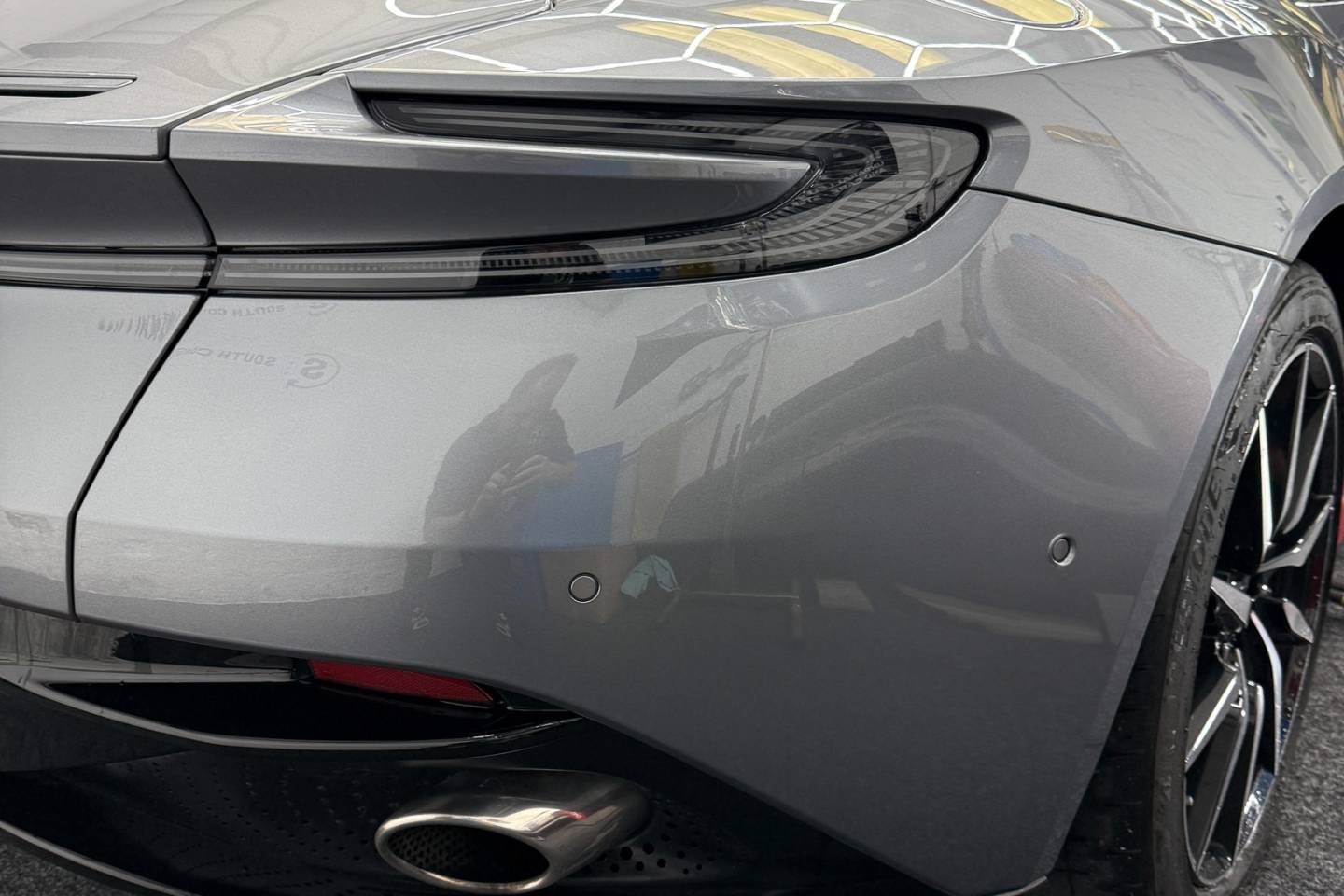 Rear bodywork and tail lamp on a grey sports car