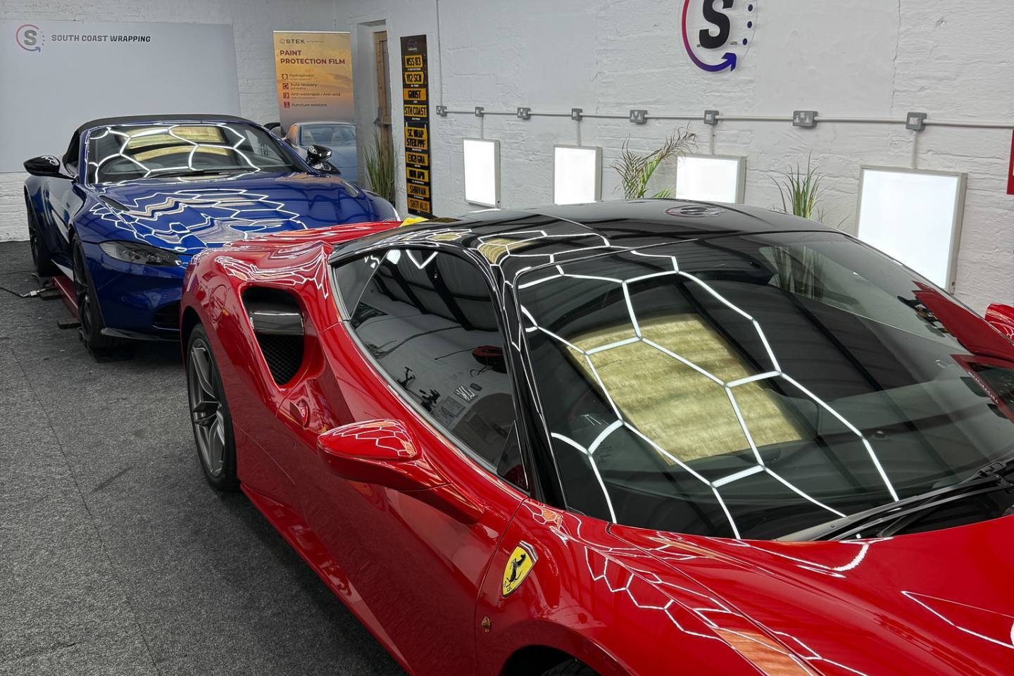 Sports cars inside the South Coast Wrapping workshop