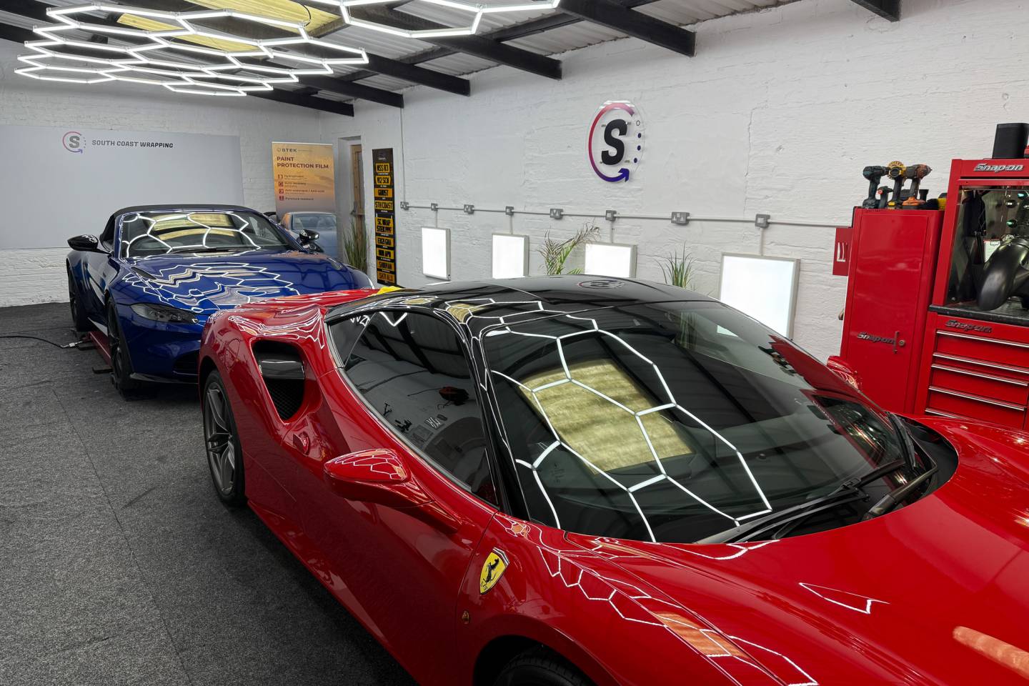 Red sports car roof and windscreen in the workshop
