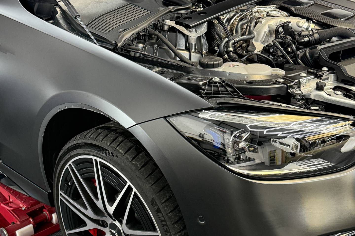 Grey Mercedes with the bonnet open in the workshop