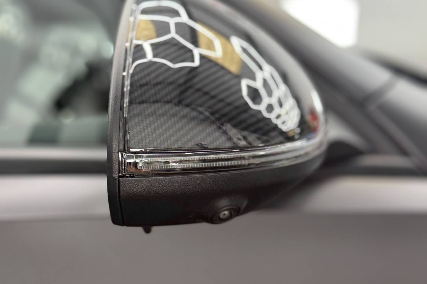 Carbon-finish wing mirror on a Mercedes