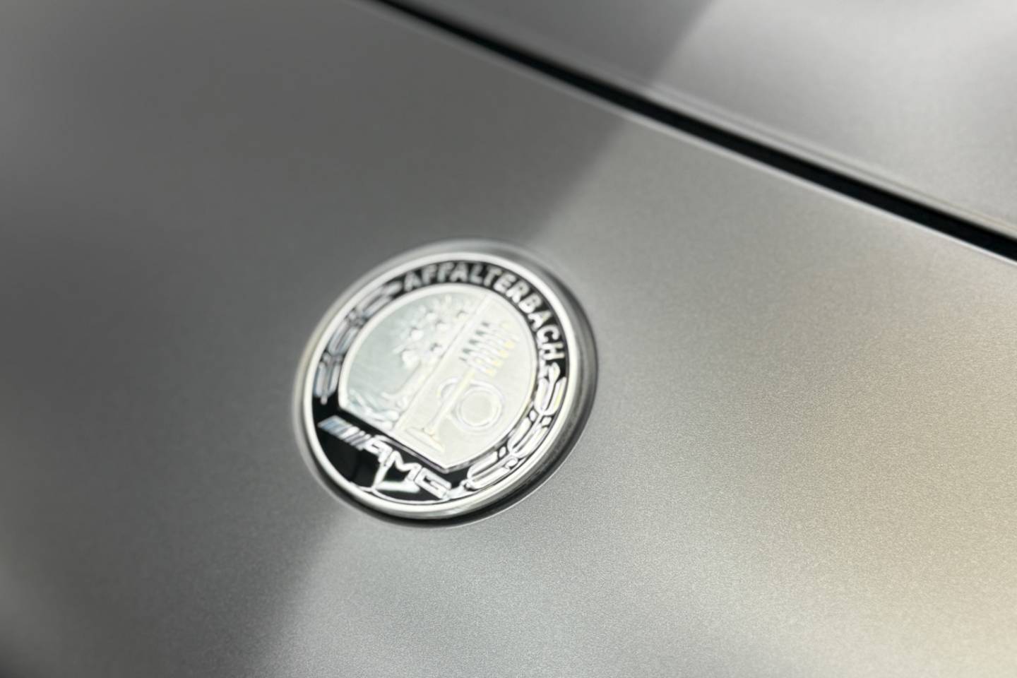 Mercedes badge on a matte-finish body panel