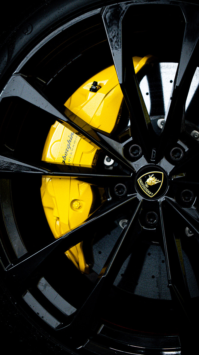 Black Lamborghini alloy wheel with yellow brake calliper