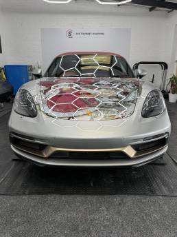 Front view of Porsche convertible with illustrated bonnet