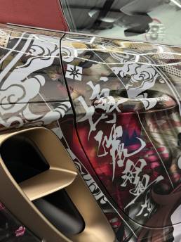 Close-up of illustrated rear quarter and gold Porsche wheel