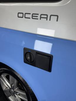 Blue lower bodywork beneath VW Transporter Ocean branding
