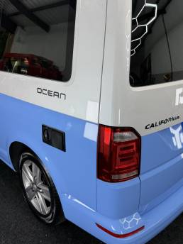 Rear corner of blue and white VW Transporter Ocean