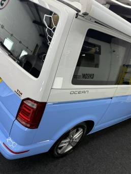 Two-tone blue and white VW Transporter rear side panel