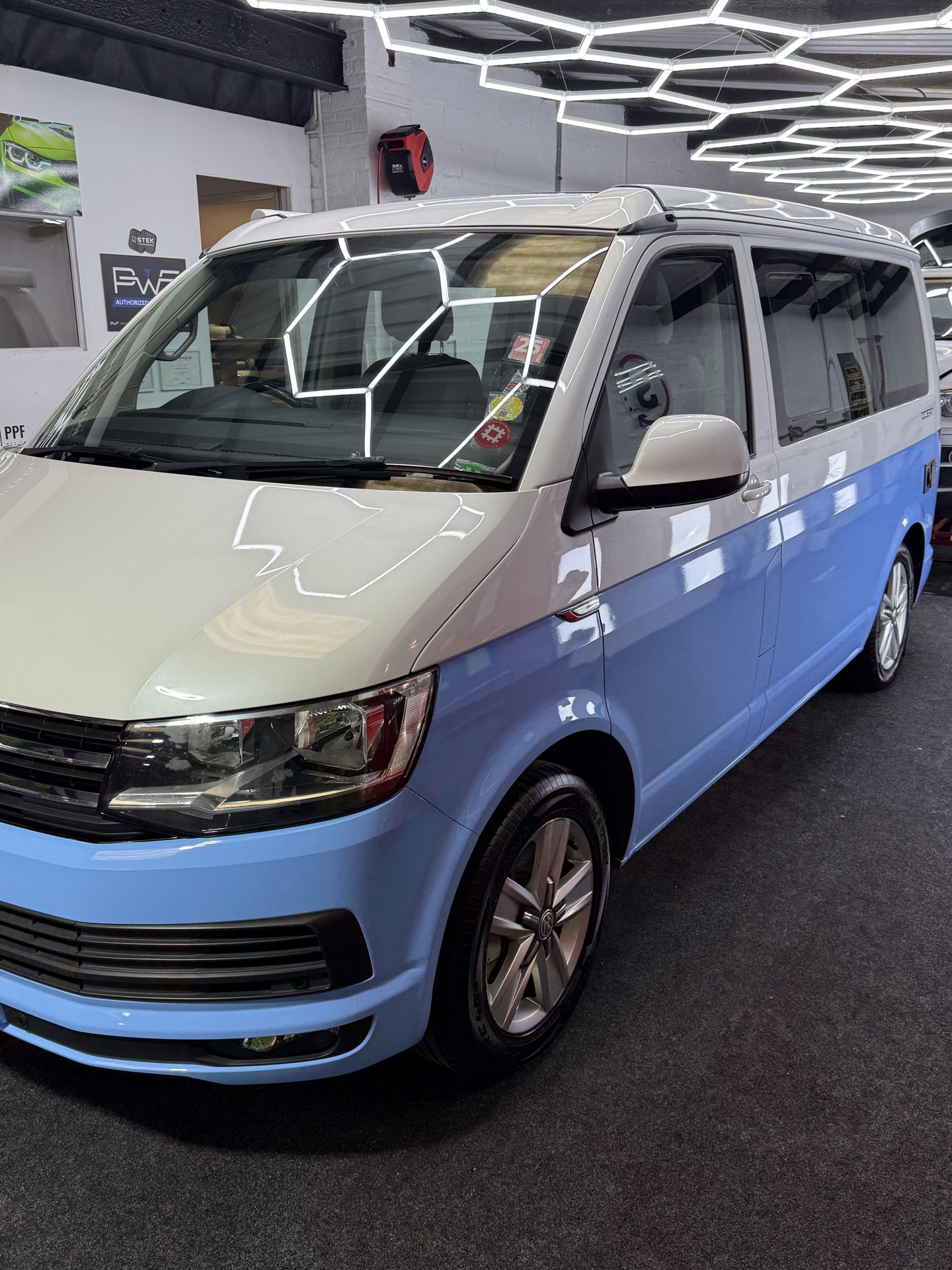 Blue and white VW Transporter Ocean in the workshop