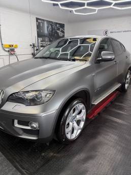 Front three-quarter view of satin grey BMW X6