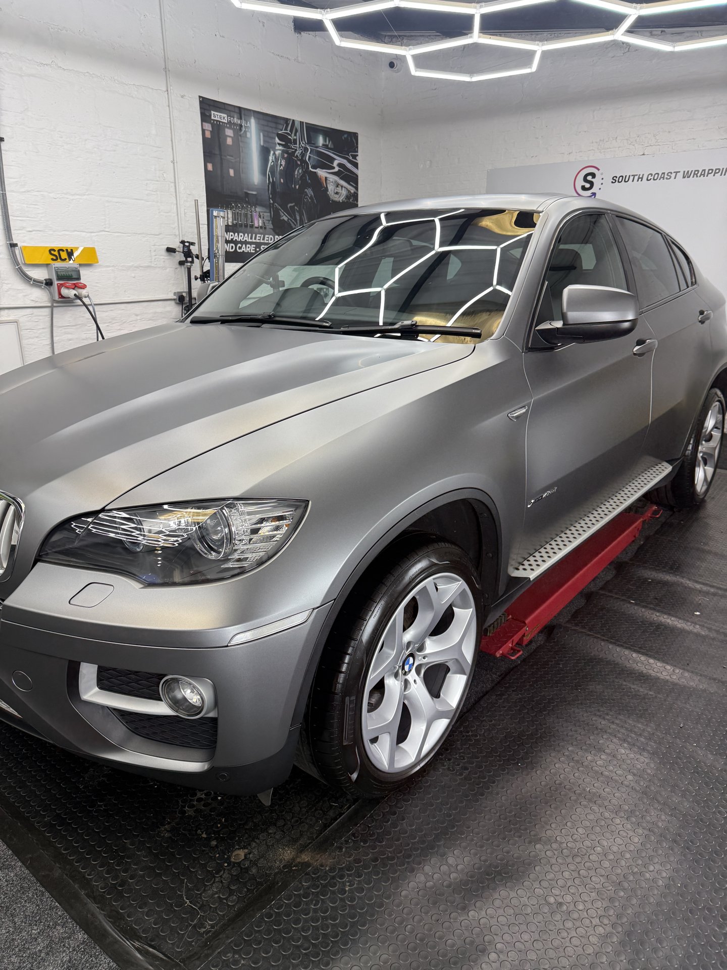 Front three-quarter view of satin grey BMW X6