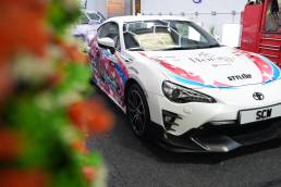 Anime-wrapped Toyota GT86 outside the workshop