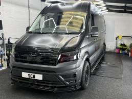 Satin grey MAN van with black wheels in the workshop