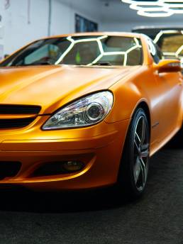 Front three-quarter view of orange Mercedes-Benz SLK 200