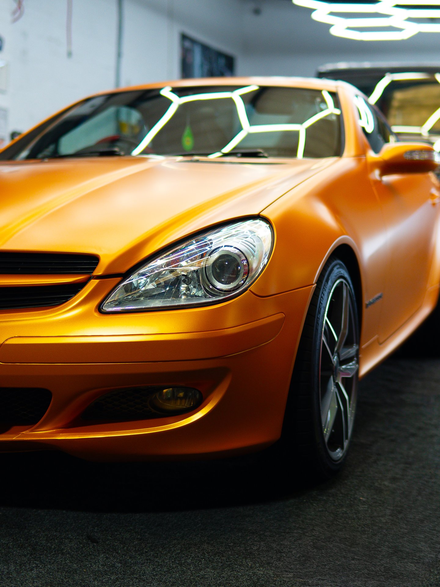 Front three-quarter view of orange Mercedes-Benz SLK 200