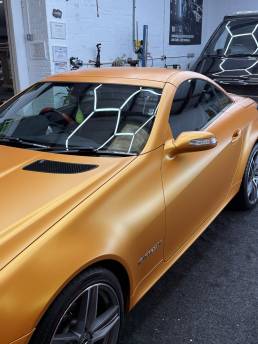 Orange Mercedes-Benz SLK 200 in the workshop