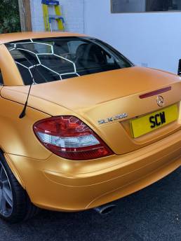 Rear quarter of orange Mercedes-Benz SLK 200