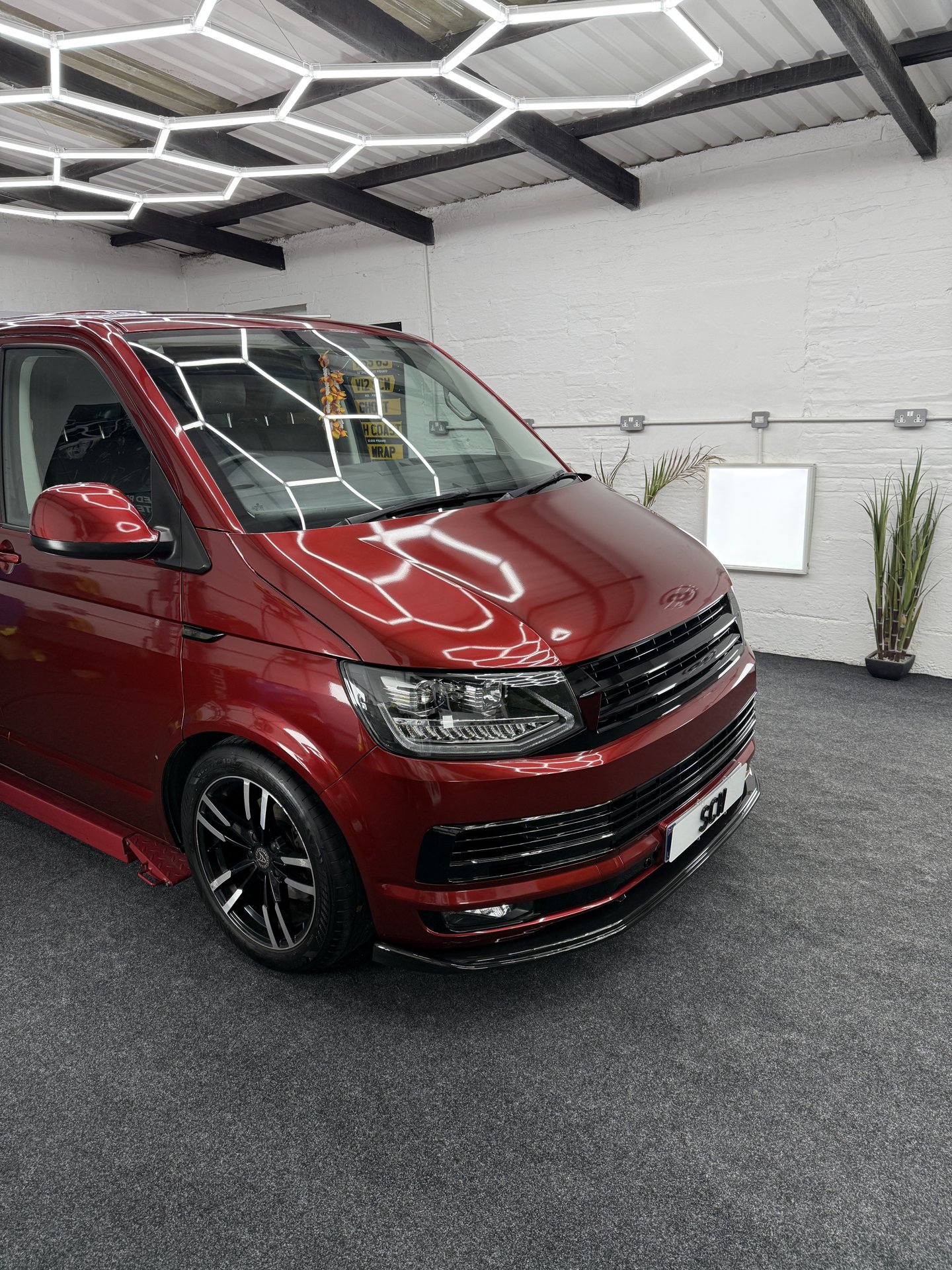 Front three-quarter view of red VW Transporter