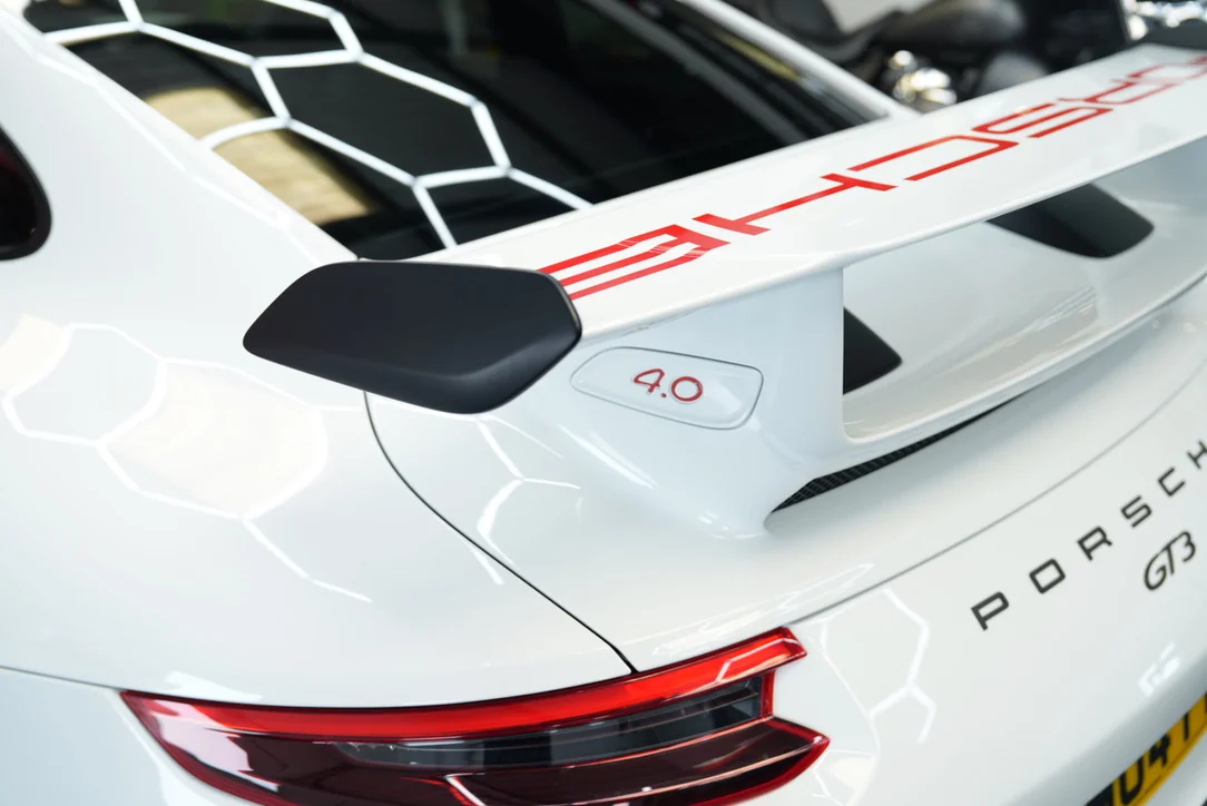Rear wing and tail-light detail of a white Porsche 911 GT3 at South Coast Wrapping