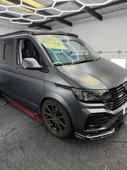Front three-quarter view of satin grey VW Transporter