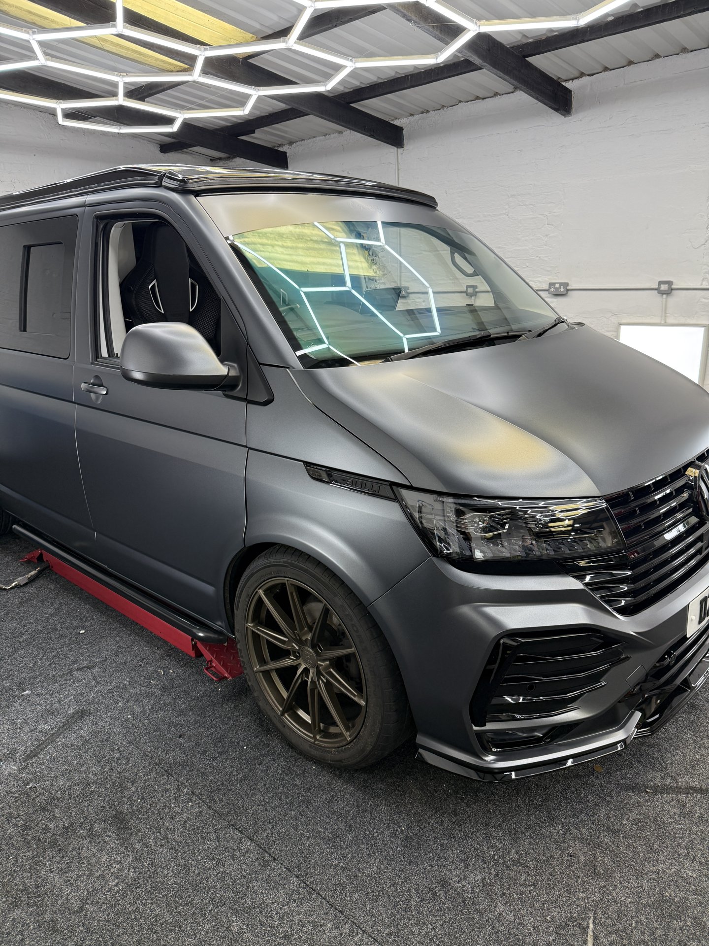 Front three-quarter view of satin grey VW Transporter