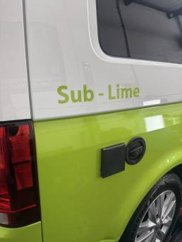 Lime green and white VW Transporter rear quarter